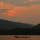 Fishermen row across Lake Kivu at sunrise off the peninsula of Kumbya, Rwanda